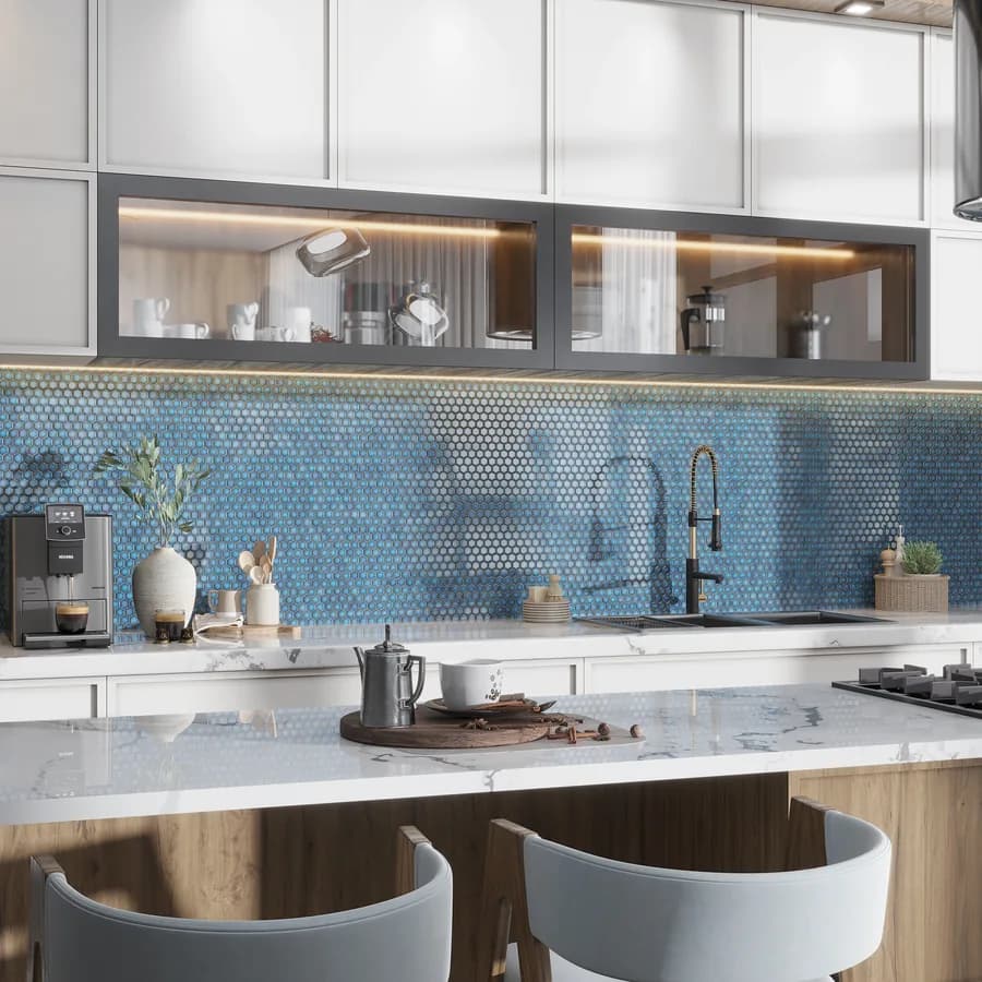 A white stone counter against a blue mosaic backsplash
