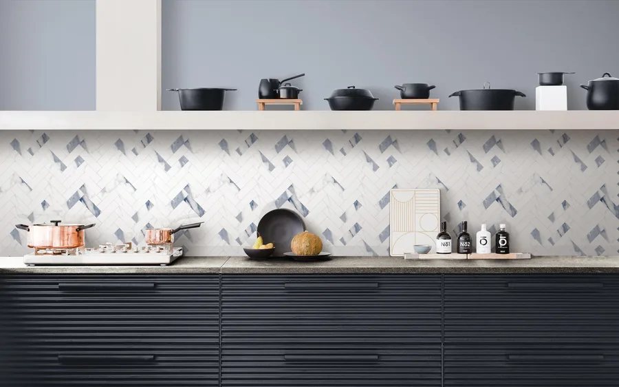 A finished kitchen backsplash in blue and white chevron tile