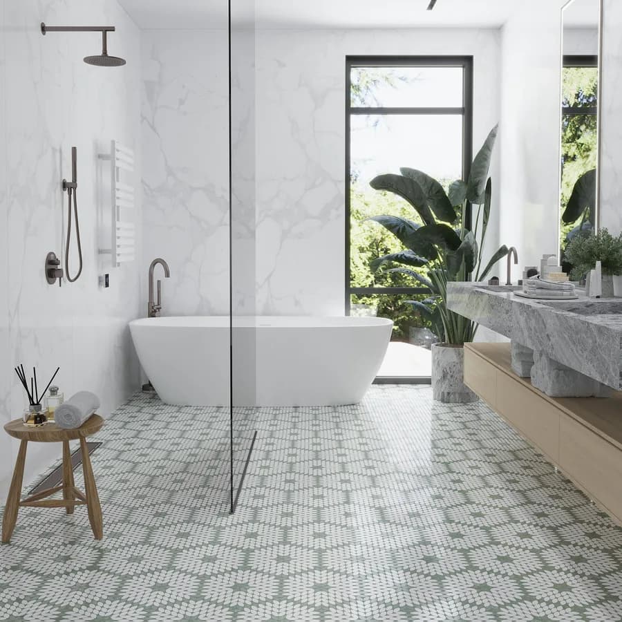 A glass-walled shower finished in marble beside a freestanding bath