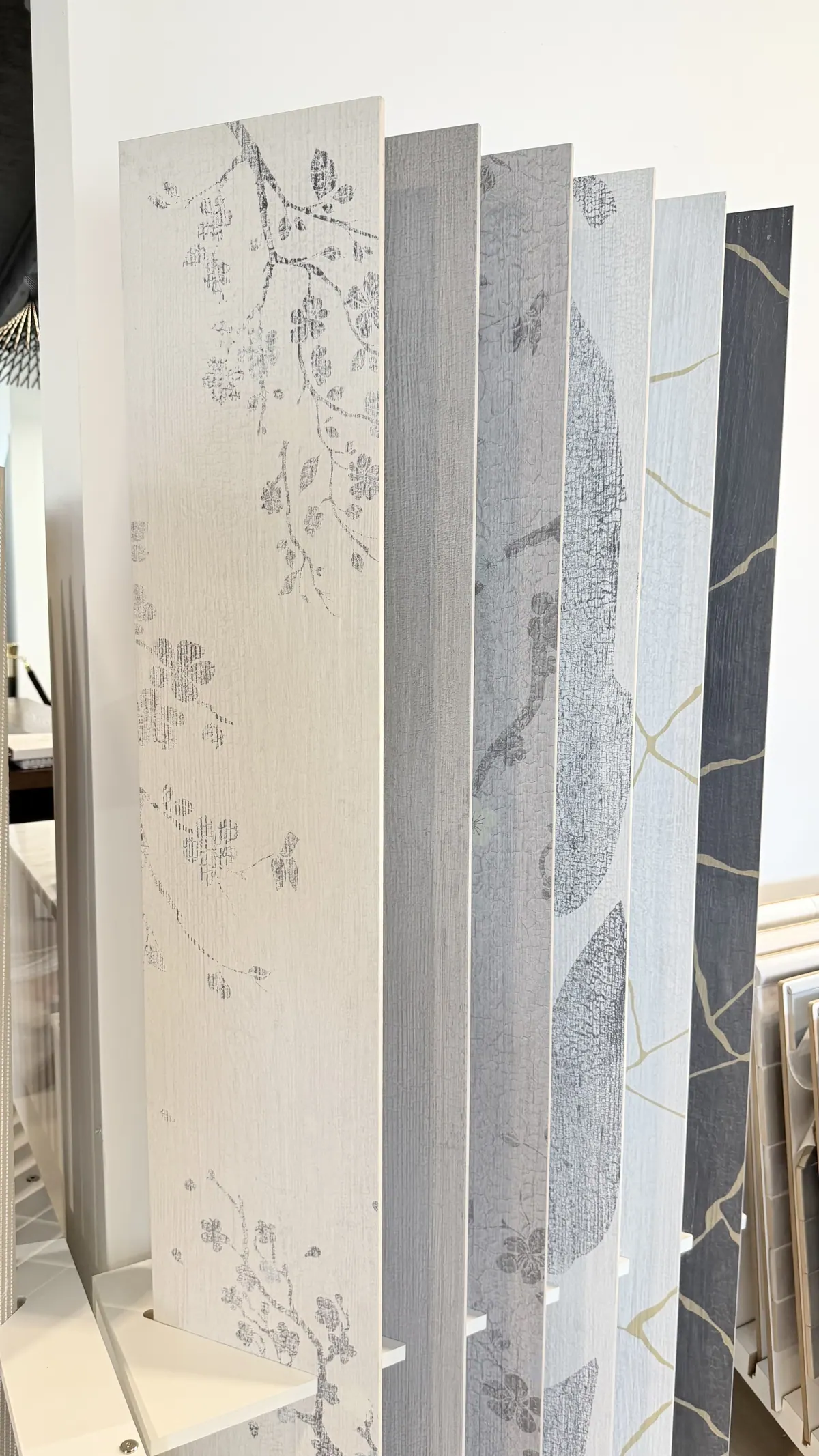 Tall decorative panels with a botanical pattern standing in the showroom