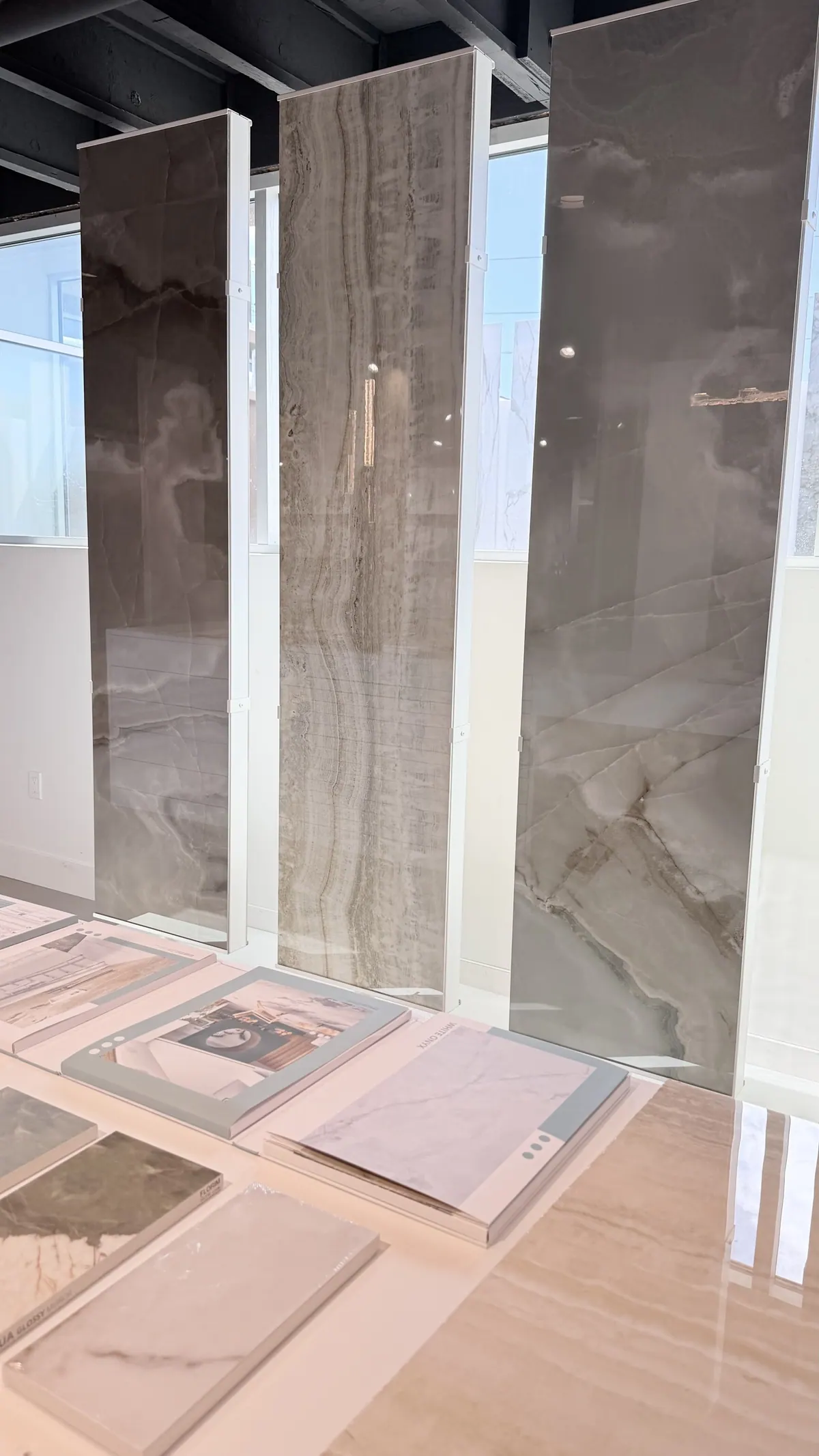 Large-format porcelain panels standing in a rack on the showroom floor