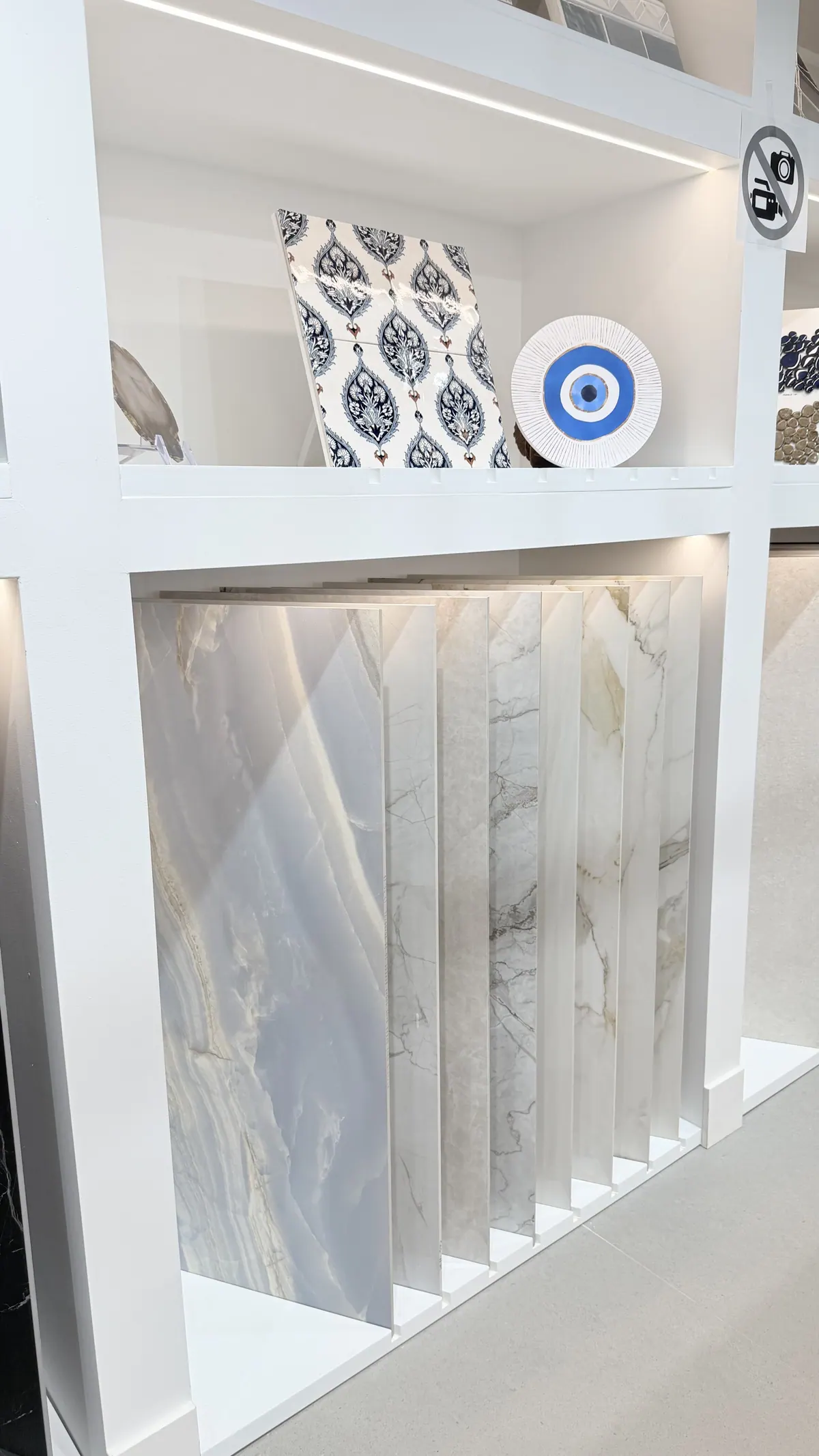 White and grey marble slabs racked upright along the showroom wall