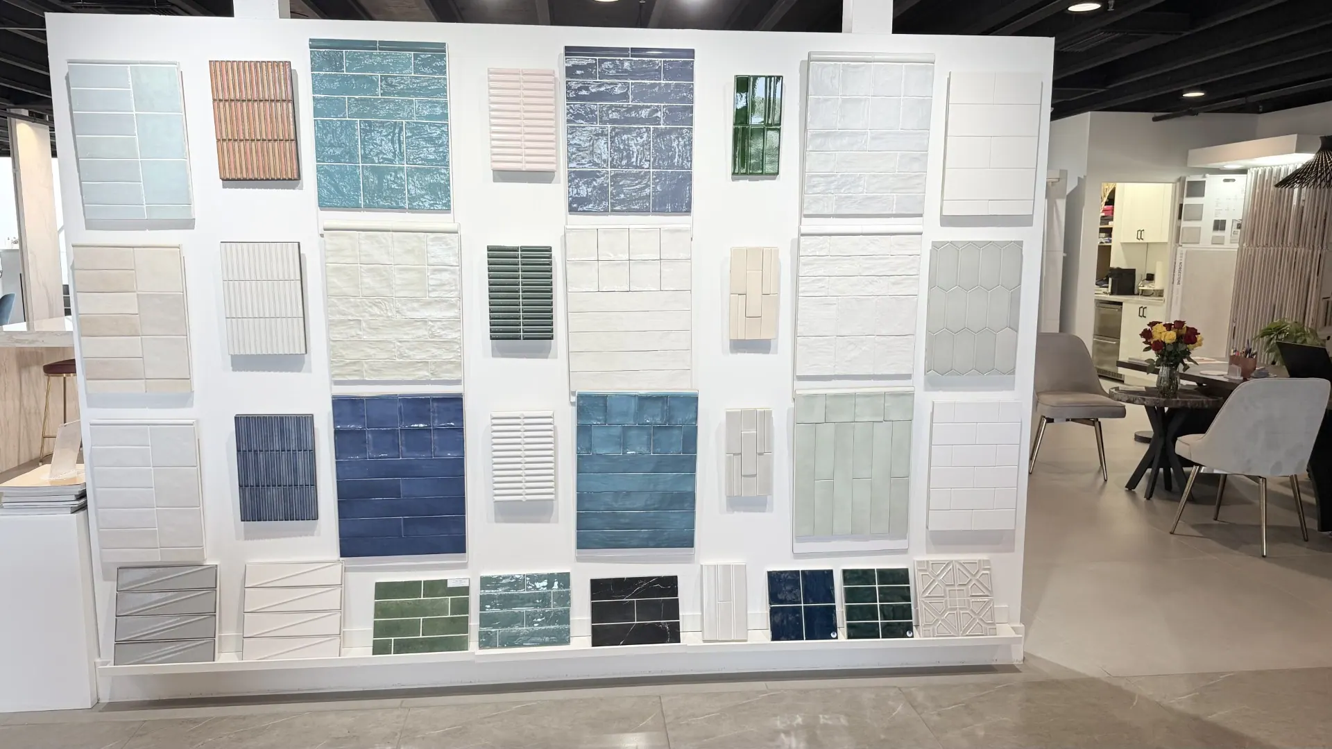 A wall of tile samples in the Segna Tile showroom, arranged by colour and finish